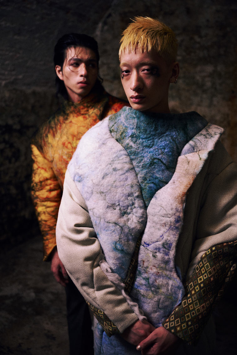 two men wear a blue color wool felting cloths in historic place, in tunnel