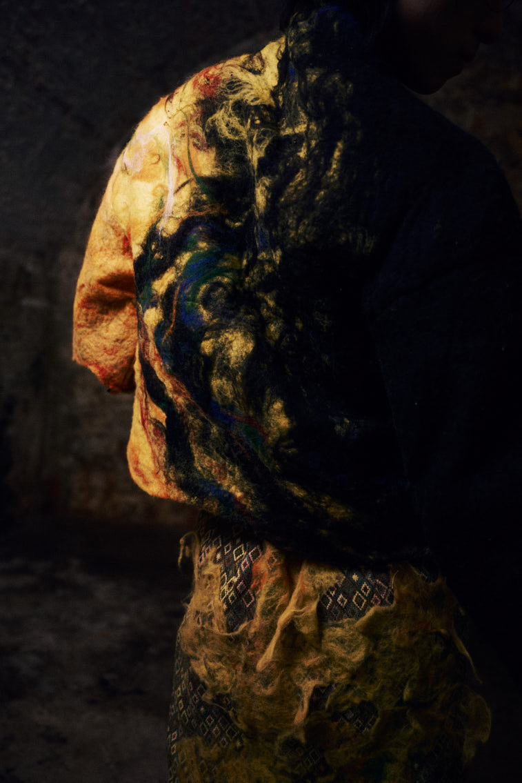 a man in wool felting cloth, warn color