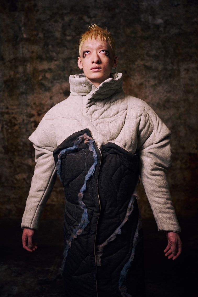a man wear a blue tone color wool felting cloth in historic place, in tunnel