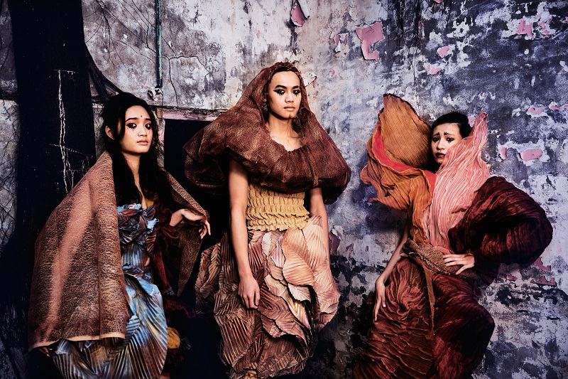 fiber art, wearable installation, three persons in a ruin